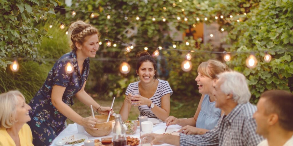 Family and friends gathered outdoors supporting a loved one in recovery housing