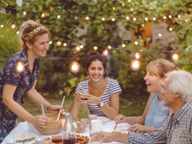 Family and friends gathered outdoors supporting a loved one in recovery housing