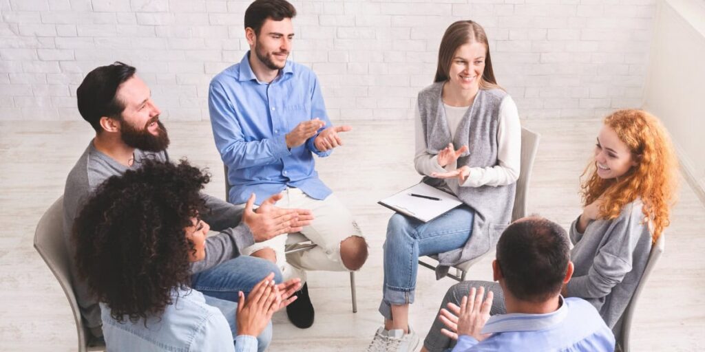 Family members sitting together in a supportive conversation representing the guidance Izzy's House provides to Ohio families choosing a sober living home